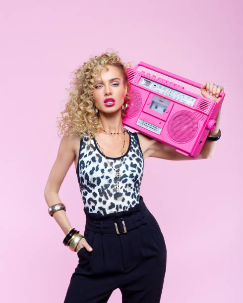 istock Confident woman in 80's style outfit holding boom box 1224841069