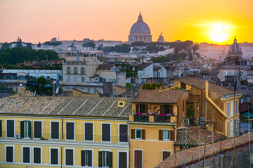 Rome, Italy, June 12 -- A warm sunset light illuminates the roofs of Rome near Piazza Campo dei Fiori and on horizon the Saint Peter's Dome, in the historic center of the eternal city. Photo in HD format