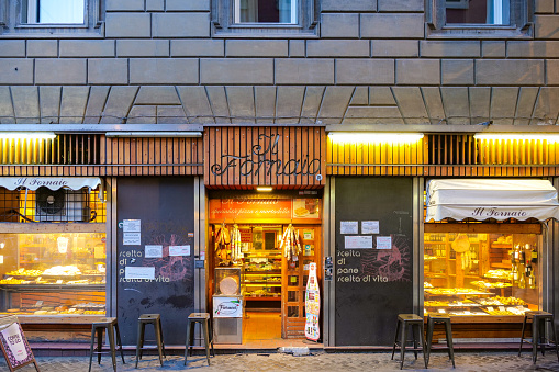 Rome, Italy, May 07 -- The evening lights illuminating the facades of a bakery near Campo de Fiori, in the heart of the eternal city. Image in HD format.