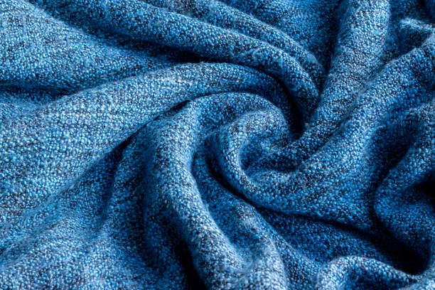 istock Bright blue knitted fabric texture. Crumpled twisted blanket background. Selective focus. Closeup view 1224841675