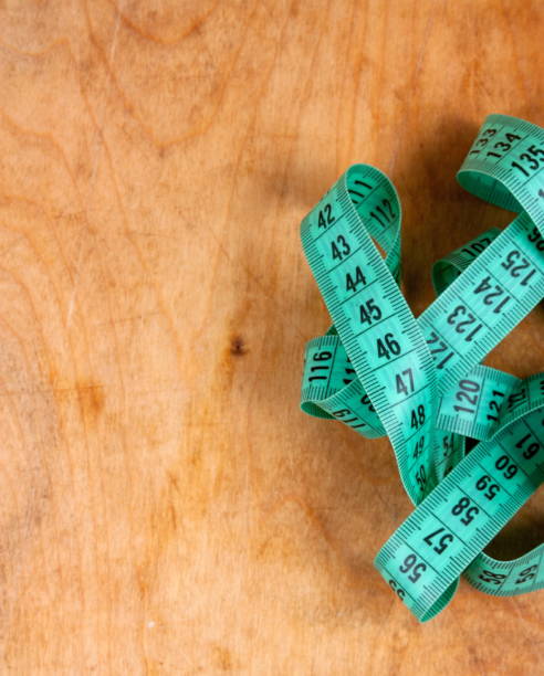 istock Measuring tape on the wooden background 1224846368