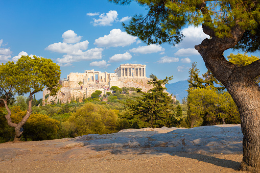 Amazing view of  Acropolis hill, Athens, Greece. Famous old Acropolis is a top landmark of Athens. Ancient Greek ruins in the Athens center in summer. Scenic view of remains of antique Athens city