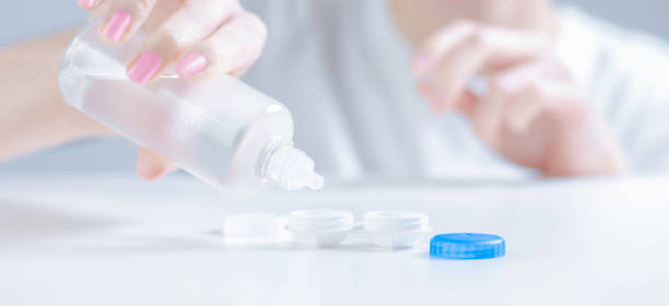 istock Woman pours liquid for lenses into special boxes. Ophthalmology concept. 1224853209