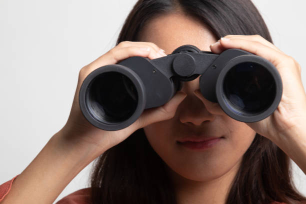 istock Young Asian woman with binoculars . 1224854386