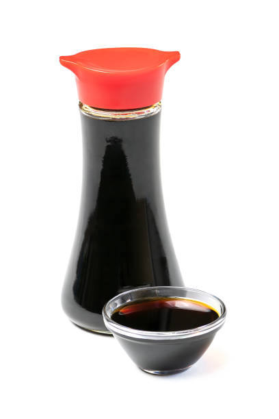 Soy sauce in glass bottle and bowl isolated on white. Soy sauce in glass bottle and bowl isolated on white background. soy sauce photos stock pictures, royalty-free photos & images