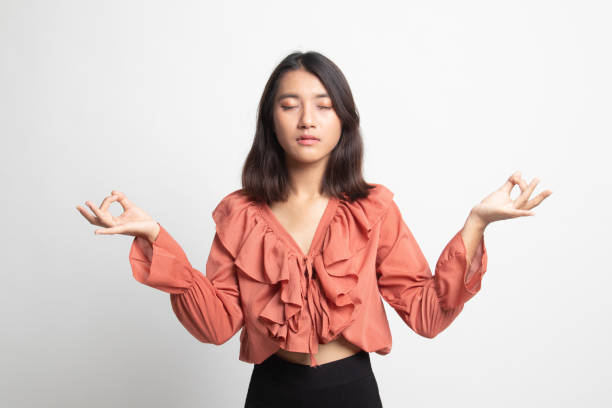 istock Concentrated relaxed  asian  female  closed eyes, having relaxation while meditating. . 1224855426