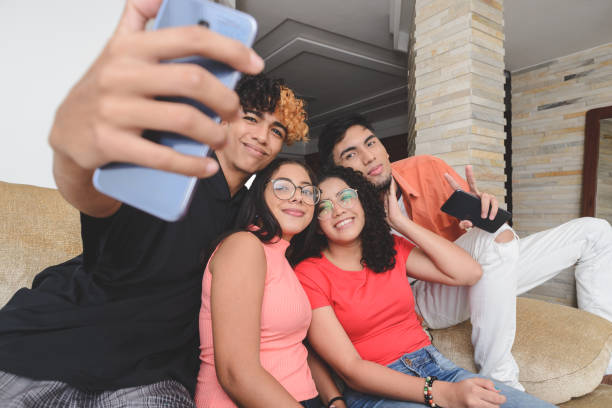 istock Multiethnic group of millennials taking selfie sitting on a couch at home 1224857159
