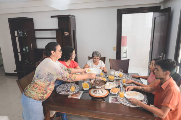 istock Family having lunch at dining table served with feijoada, typical brazilian black bean stew 1224857814
