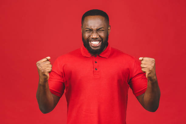 istock Cheerful handsome African american man making yes gesture while excited about winning. Ecstatic young fan rooting and expressing support. Success concept. 1224858458