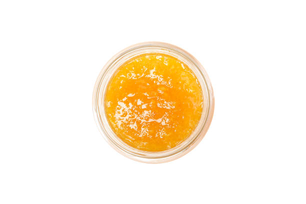 istock Glass jar with apricot jam isolated on white background 1224858615