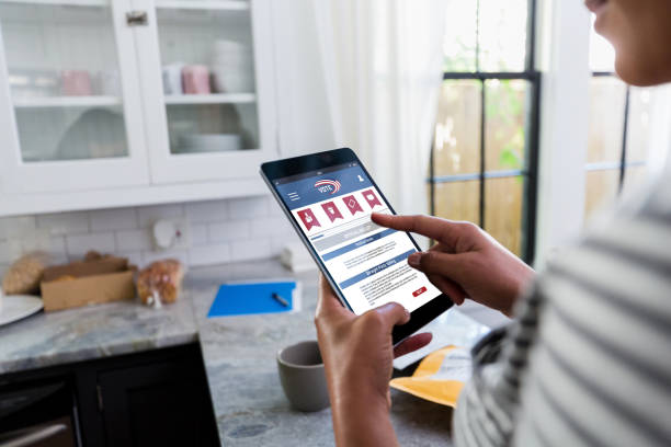 istock Woman uses digital tablet to vote online 1224860280