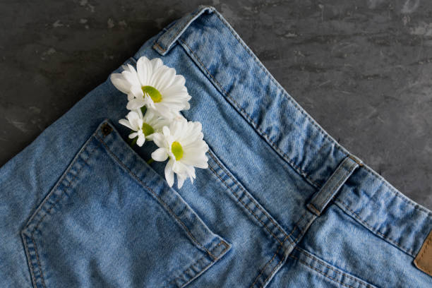 istock flowers in jeans pocket, spring mood, close-up, flat lay 1224860855