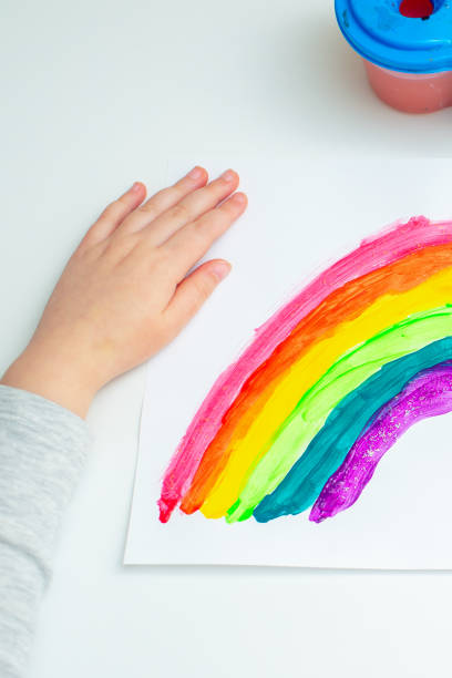 istock Kid painting rainbow during quarantine at home. 1224861197