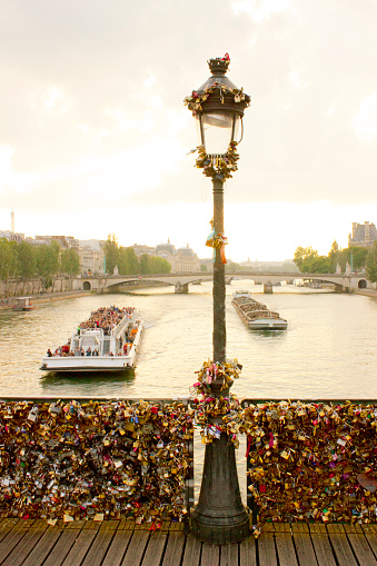 Pont des Arts with River Seine in the background and boat at sunset