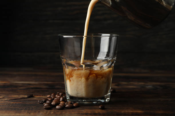 istock Milk is poured into a glass of coffee. Composition with ice coffee 1224863895