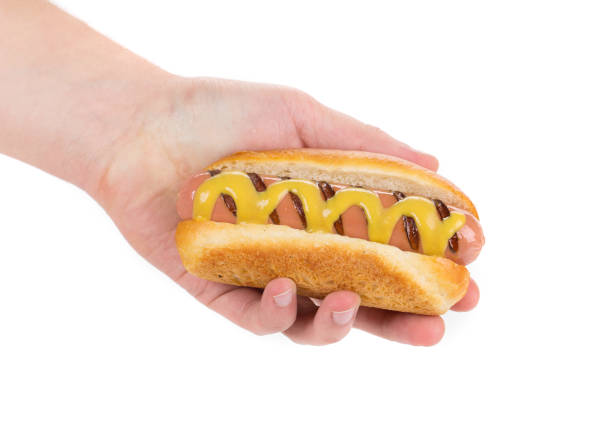 istock Hotdog with mustard in a hand. 1224864879