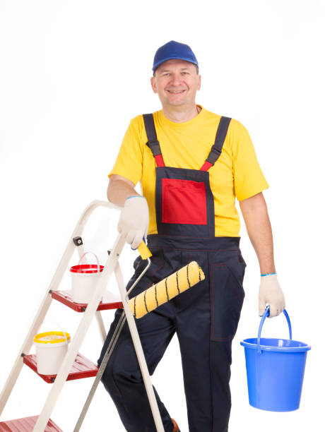 istock Worker in hardhat holds paint roller and bucket of paint. 1224865513