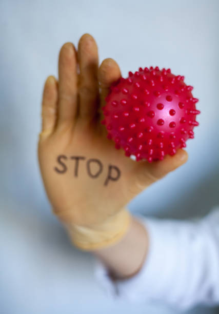 istock Stop Covid-19. Text on medical glove. 1224866031