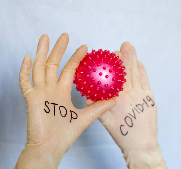 istock Stop Covid-19. Text on medical gloves. 1224866034