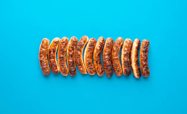 Grilled nuremberger bratwurst. German sausages top view Above view with grilled german sausages, alligned on a blue background. Authentic grilled nuremberger bratwurst weisswurst photos stock pictures, royalty-free photos & images