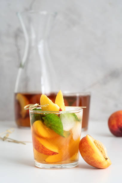 istock Iced cold peach tea with fruit slices and mint 1224871434