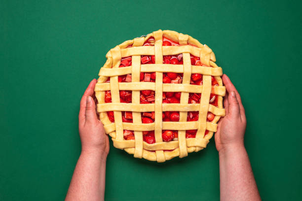 istock Uncooked fruit cake top view in a woman hands 1224873119