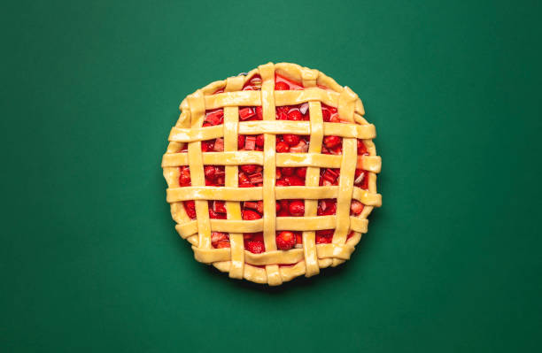istock Uncooked strawberries rhubarb pie top view on a green background 1224873148