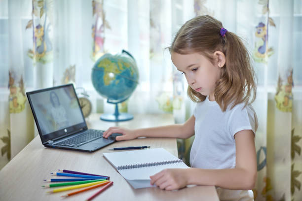 Girl doing homework at home stock photo