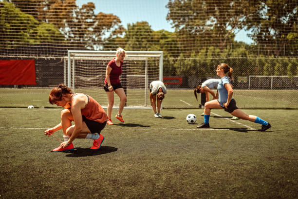 istock Athlete tying shoelace and warming up on soccer field 1224884031