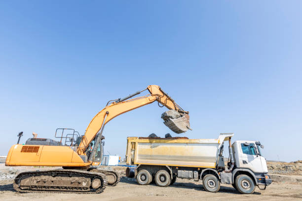 istock The excavator is loading big rocks to dump truck in the construction site. 1224884772