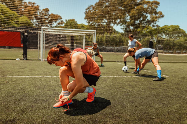 istock Athlete tying shoelace and warming up on soccer field 1224885808