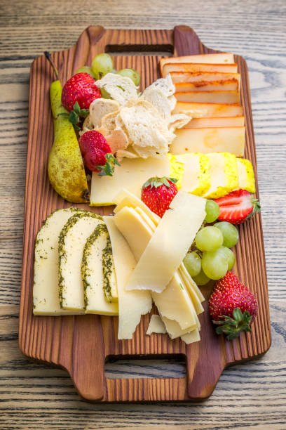 istock Cheese plate with various cheese, strawberries 1224886508