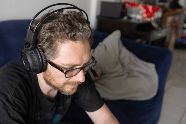 istock Man with Headphones on Lockdown Gaming Online 1224887072