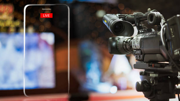 Video camera taking live video streaming with lighting frame of mobile phone and Live text at meeting room. Video camera taking live video streaming with lighting frame of mobile phone and Live text at meeting room. live broadcast photos stock pictures, royalty-free photos & images