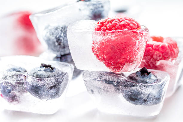 istock frozen blueberry and raspberry in icecubes on white background 1224887208
