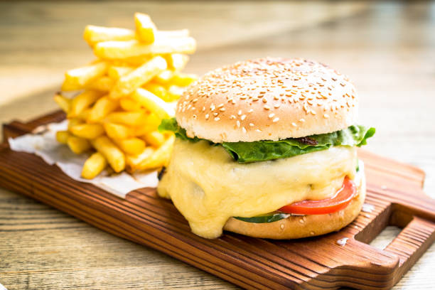istock Fresh cheeseburger with melting cheese, tomatoes 1224887304