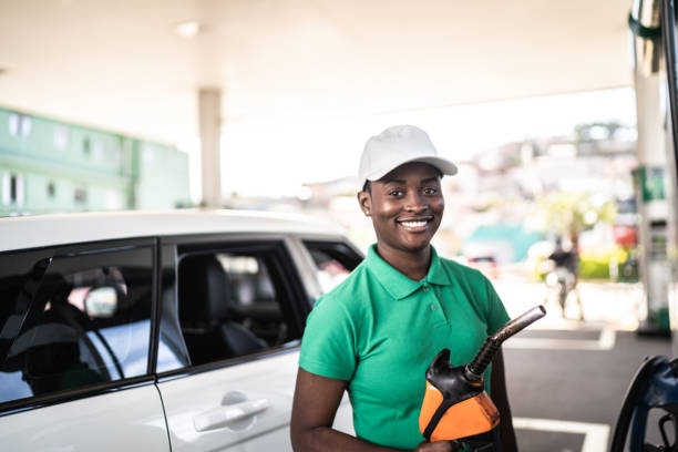 Portrait of female gas station attendant at work Portrait of female gas station attendant at work ethanol photos stock pictures, royalty-free photos & images