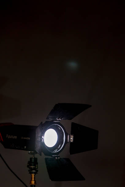 istock Studio lighting spotlight. Warm stage spotlight shines on dark background 1224888286