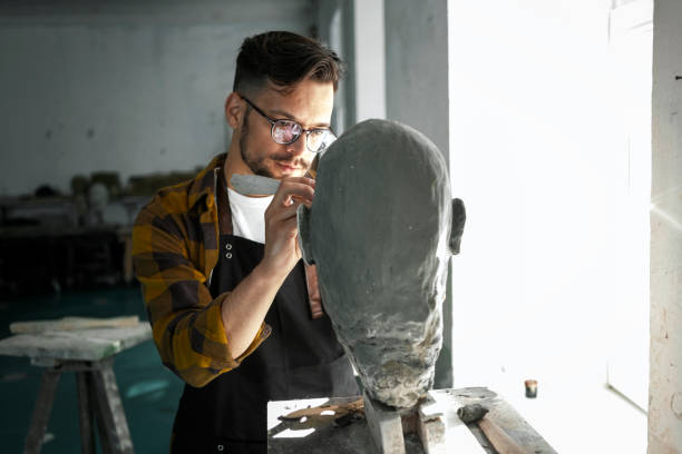 Male Sculptor working on a clay bust