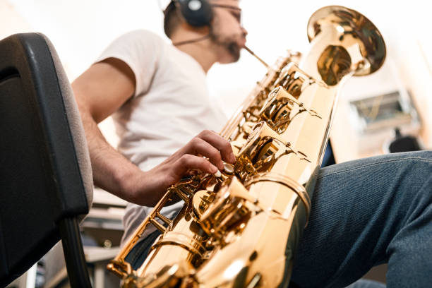 istock Young man playing saxophone ,focus on fingers 1224889460