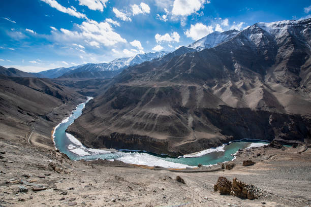 Indus River in Ladakh, Nothern India Indus River in Ladakh between Leh and Lamayuru, Nothern India in an altitude of approx. 3550 m. The Indus is a major south-flowing river in South Asia and with 3,180 km (1,980 mi) one of longest rivers in Asia. The Indus is also strategical important because it comes from India and flows into Pakistan where it provides key water resources for Pakistan's economy. The ultimate source of the Indus is in Tibet; the river begins at the confluence of the Sengge Zangbo and Gar Tsangpo rivers that drain the Nganglong Kangri and Gangdise Shan (Gang Rinpoche, Mt. Kailas) mountain ranges. The Indus then flows northwest through Ladakh and Baltistan into Gilgit, just south of the Karakoram range. karakoram range stock pictures, royalty-free photos & images