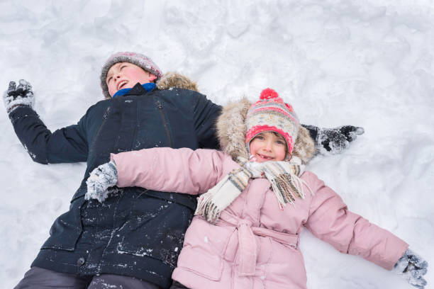 istock Children play outdoors in winter. Winter vacation 1224889635