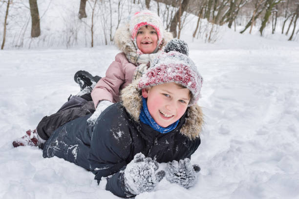 istock Happy children have fun playing in a snowdrift outdoors in winter. 1224890416