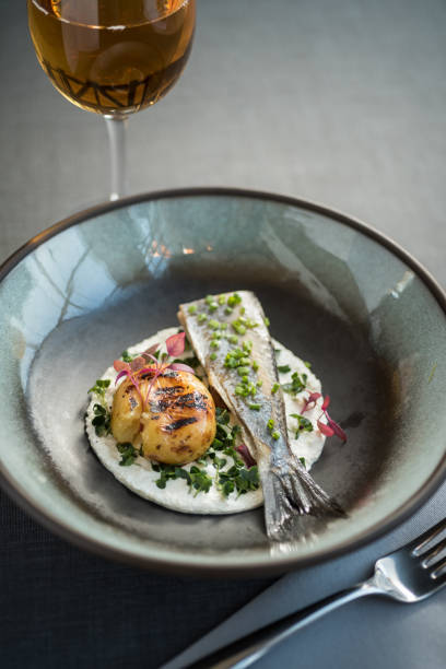 istock Cooked white fish with baked potato, spring onions 1224891302