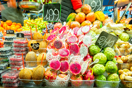 Colorful fruit variety display in farmers market store. Fresh raw ripe agricultural produce food from local farms. Delicious healthy vegan/ vegetarian diet grocery items on shelf in retail shop.