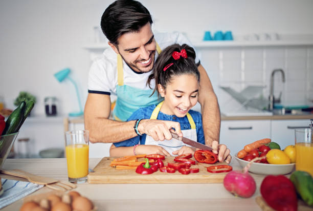 istock Father and daughter are cooking together in a kitchen 1224894879