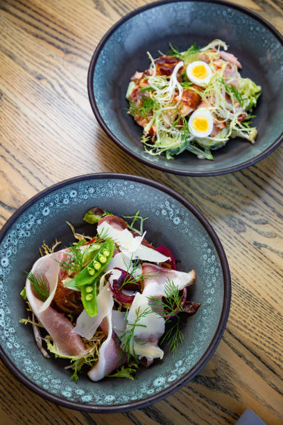 istock Smoked ham salad with fresh leaves, green peas 1224895816