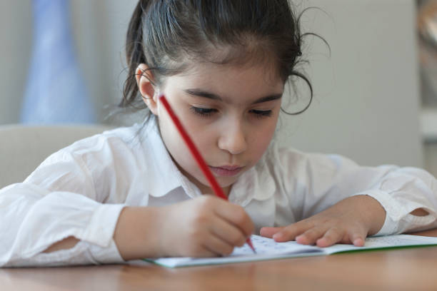istock Child girl studying at home 1224896764