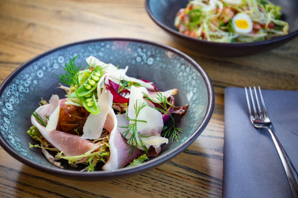 istock Smoked ham salad with fresh leaves, green peas 1224897056