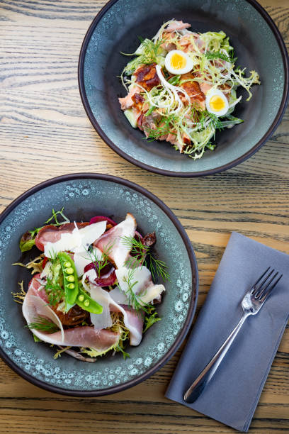 istock Smoked ham salad with fresh leaves, green peas 1224898331